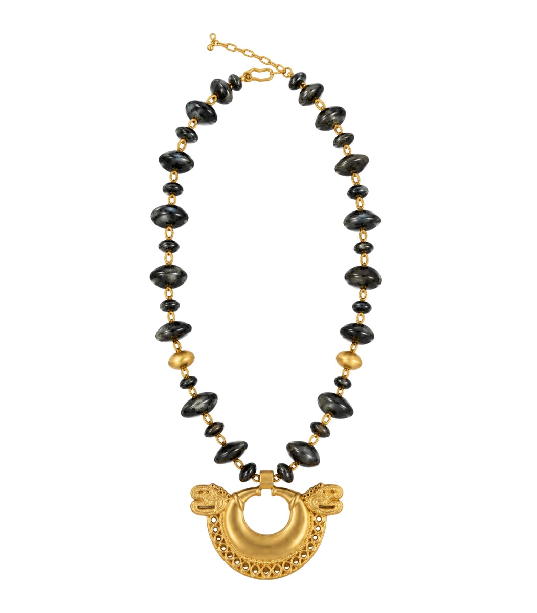 A gold and black beaded necklace featuring a large gold crescent moon pendant with dragon heads on either side, displayed on a clean white background.