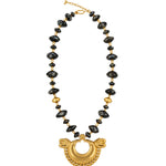 A gold and black beaded necklace featuring a large gold crescent moon pendant with dragon heads on either side, displayed on a clean white background.