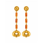 A pair of gold dangle earrings with textured circular studs, orange cylindrical spacer beads, and a large gold oval drop at the bottom, shown on a plain white background.