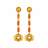 A pair of gold dangle earrings with textured circular studs, orange cylindrical spacer beads, and a large gold oval drop at the bottom, shown on a plain white background.