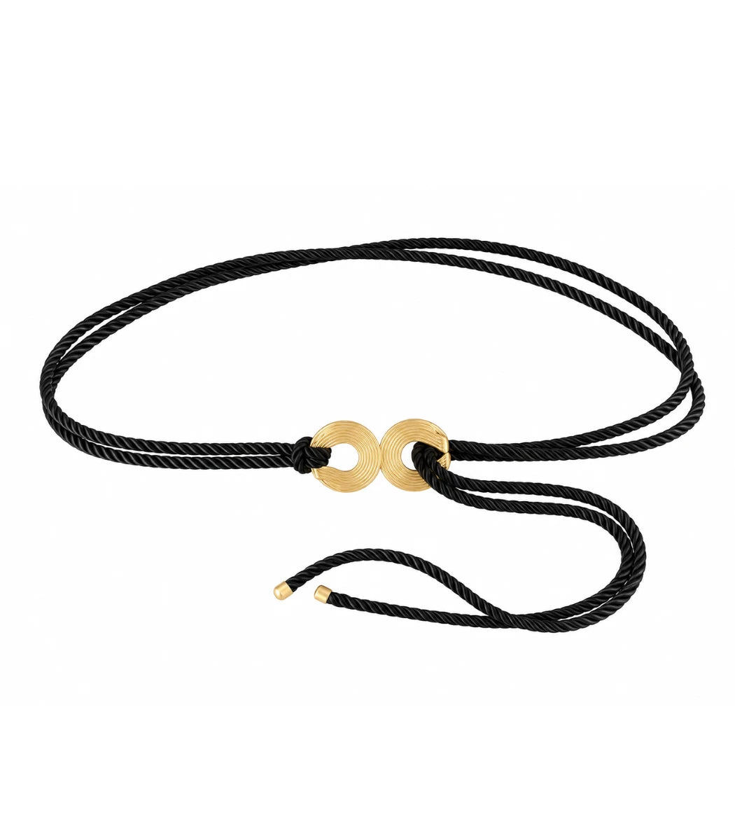 A double-strand black cord bracelet with two polished gold circular disc charms in the center, displayed on a clean white background.