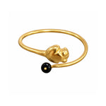A gold-plated open cuff ring featuring a sculpted rabbit head charm and a small black bead accent, shown against a plain white background.