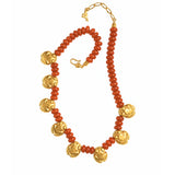 A beaded necklace featuring textured orange-red coral-like beads and polished gold-toned floral medallions, displayed on a clean white background.