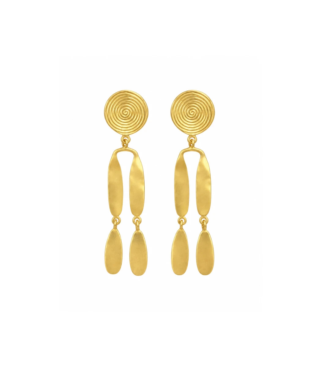 A pair of gold dangle earrings with a spiral disc design on the top, connected to elongated oval links, and ending in teardrop-shaped drops, shown against a plain white background.