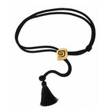 A black twisted rope bracelet with a gold square slide clasp featuring a Greek key spiral design and a matching black tassel, shown on a plain white background.